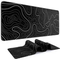 Black desk mat with white topographic line pattern, extended mouse pad design