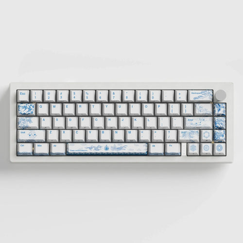 White mechanical keyboard with blue pottery-inspired artisan keycaps and decorative designs
